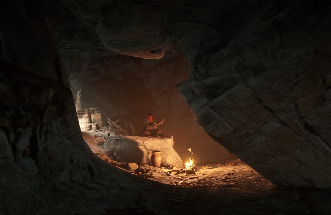 A lone figure playing guitar by a campfire inside a hideout cave